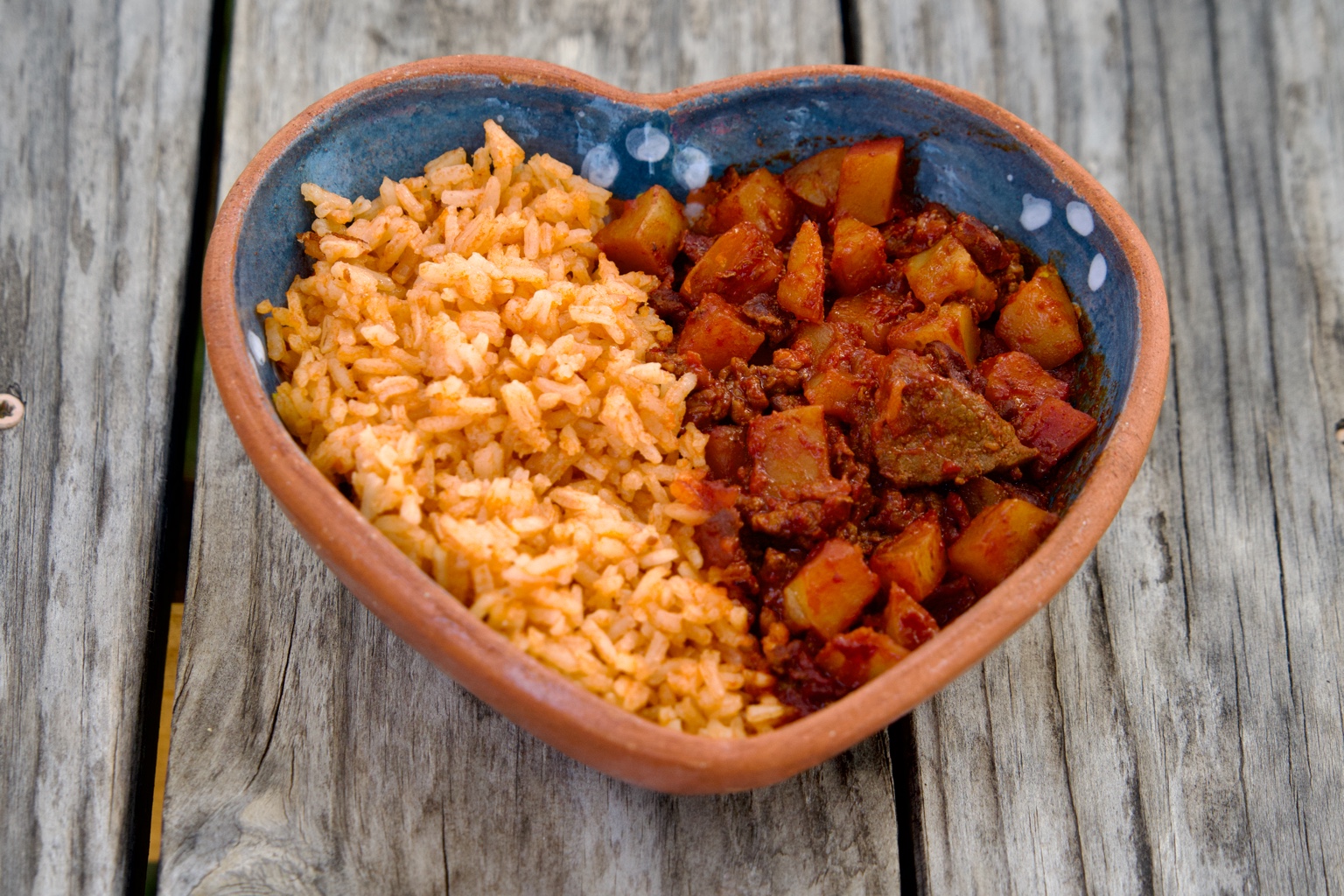 Rice bowl with Mexican rice and Chile Colorado beef and potatoes
